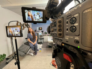 Behind the camera filming a medical course video to enhance in-office medical training fpr onboarding emloyees.